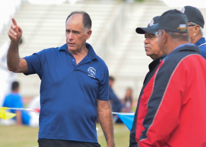 MIL Track & Field Association's head official Allan Fernandez talks with the finishing crew in between races Thursday at the Kamakea Memorial Championships. Photo by Rodney S. Yap.