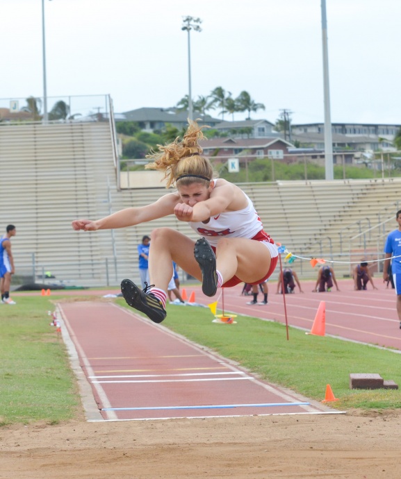 Seabury Hall's Alyssa Bettendorf reaches for the pit in the girls long jump. Photo by Rodney S. Yap.