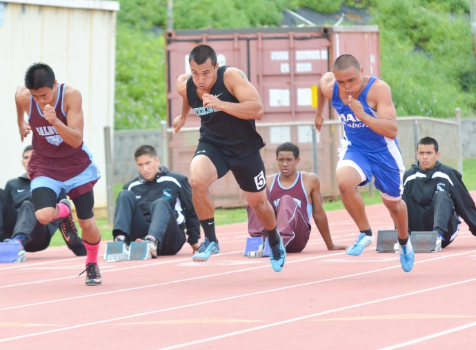 King Kekaulike's Jay Braun won the boys 100 and 200. Here he is pictured at the start of the boys 100 where he is being pushed by Baldwin's Bailey Kuapki and Maui High's mario Fernandez. Seabury Hall's Alyssa Bettendorf reaches for the pit in the girls long jump. Photo by Rodney S. Yap.
