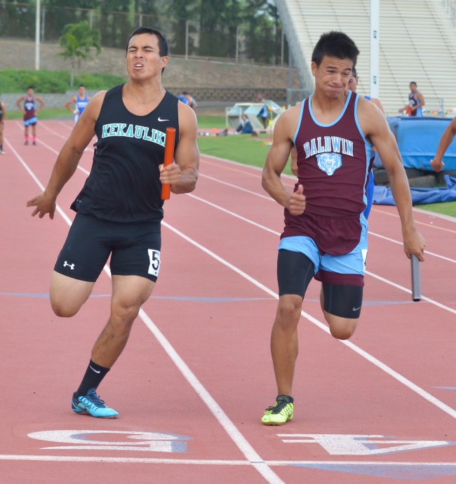 Kekaulike's Jay Braun and Baldwin's Dylan Leigh get ready to lean for the finish of the 4 x 100 relay. Photo by Rodney S. Yap.