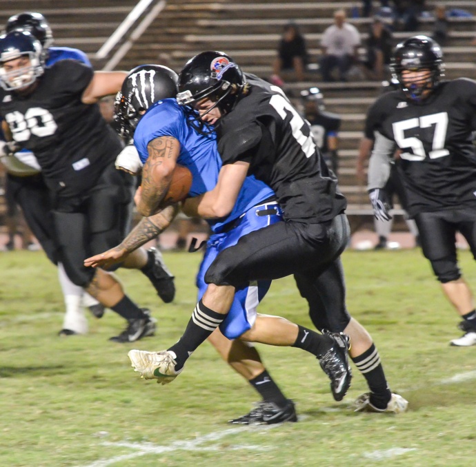 King Kekaulike's Landen Kerbow wraps up Maui High running back Keala Aiwohi during first-half action Saturday at War Memorial Stadium. Kerbow was active, despite having his right arm heavily wrapped, finishing with back-to-back sacks as time expired. Photo by Rodney S. Yap.