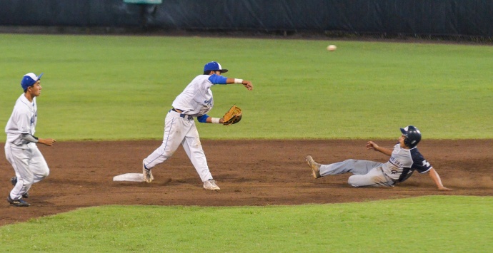 Maui High second baseman Kao Mindoro completes a double-play to end the inning as Kamehameha Schools Maui third baseman Chase Alexander slides into second base. Photo by Rodney S. Yap.
