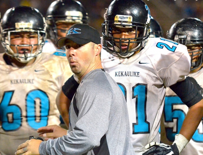 King Kekaulike head football coach Kyle Sanches talks to the defense during a timeout last season. File photo by Rodney S. Yap. 