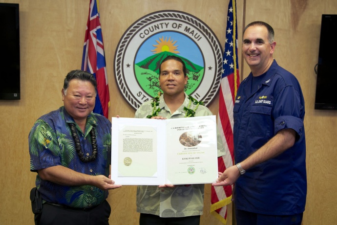 Maui County Lifeguard Keoki Pfaeltzer was awarded a Certificate of Valor by Capt. Shannon Gilreath, Coast Guard Sector Honolulu commanding officer and Maui Mayor Alan Arakawa in an award ceremony held at the Maui County Mayor's Office, May 30, 2014. Pfaeltzer was recognized for his efforts in rendering assistance to a distressed snorkeler off the shores of Ma'alaea Bay, Maui, June 14, 2013. (U.S. Coast Guard photo by Lt. Kevin Cooper)