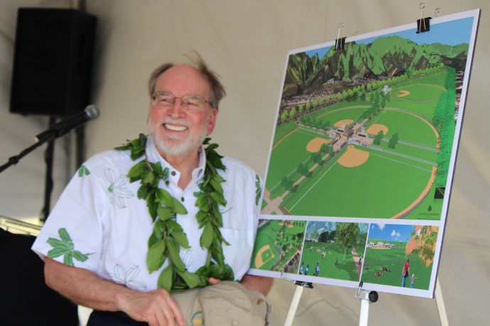 Governor Neil Abercrombie posing next to a project rendering for the future  Central Maui Regional Sports Complex.