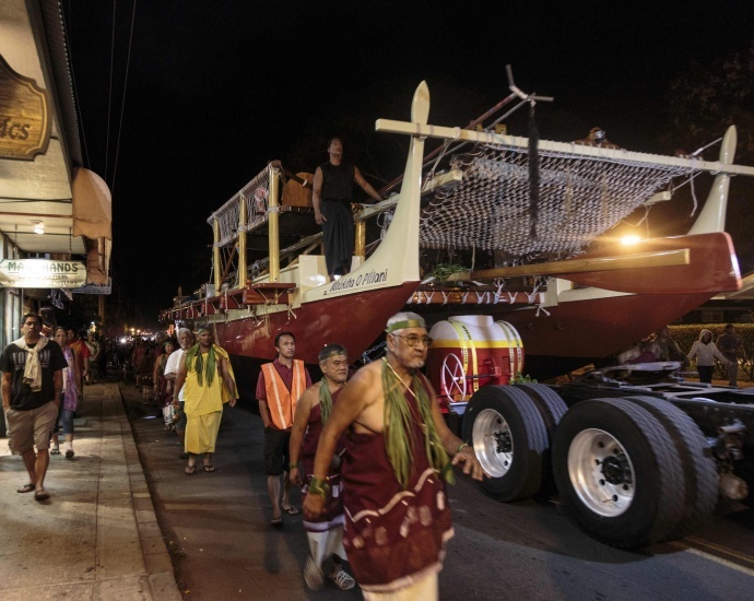 The Mo'okiha o Pi'ilani canoe is rolled up Front Street at around midnight, July 7. Photo by Charles Osborn.