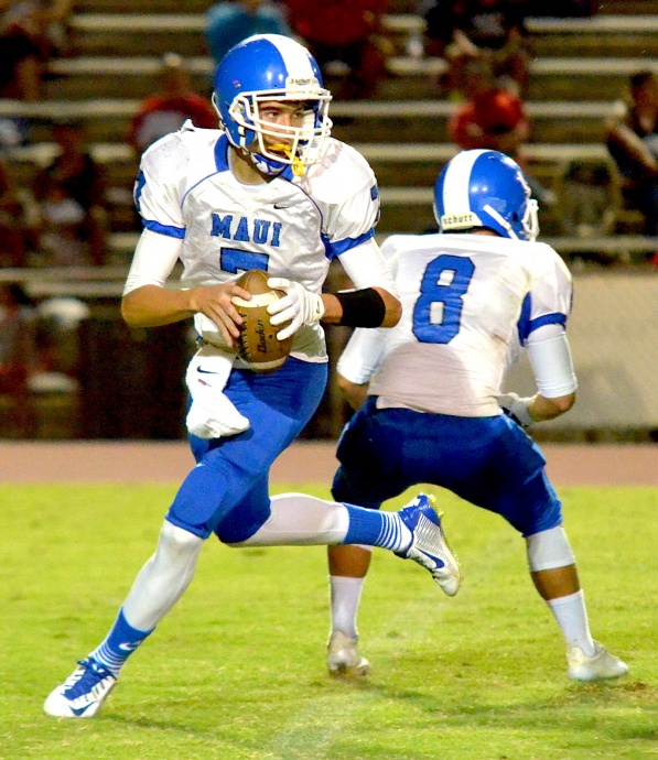 Maui High quarterback Austin Hoe rolls to his right against Maui High as teammate Tyson Takahashi looks for someone to block. Photo by Rodney S. Yap.