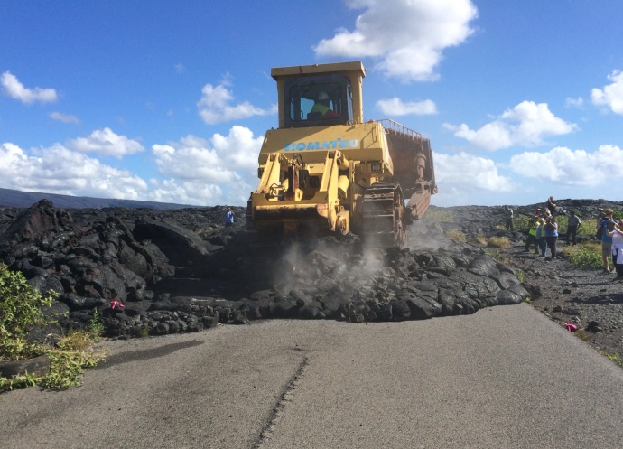 Work began today in Hawaiʻi Volcanoes National Park on the emergency access route between the park and lower Puna on the historic Chain of Craters Road-Kalapana road alignment. Park staff removed the iconic "Road Closed" sign before the first bulldozer rolled onto the lava-covered roadway. Photo courtesy of the National Park Service.