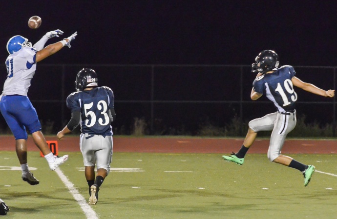 Maui High's Atunaisa Vainikolo (71) gets a piece of this punt by Kamehameha Maui's Zach Romero (19) during second-half action Saturday. Photo by Rodney S. Yap.