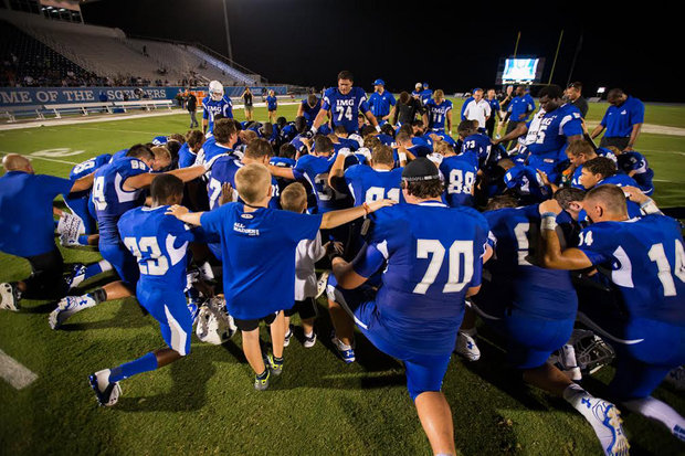 Maui's Miki Fifita leads the team prayer after a recent IMG Academy game. IMG Academy photo.