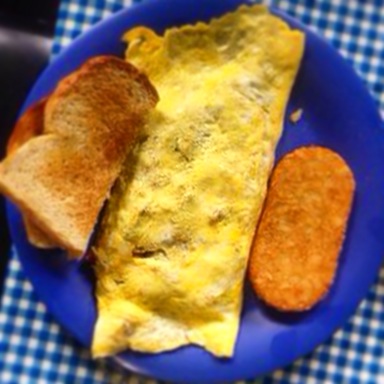 The Lanai Omelet comes with an oval orb of potatoes. Photo by Vanessa Wolf