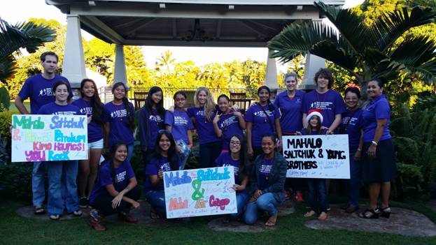 Members of Big Brothers Big Sisters hold mahalo signs, thanking Saltchuk for their generosity.  Photo courtesy BBBS.