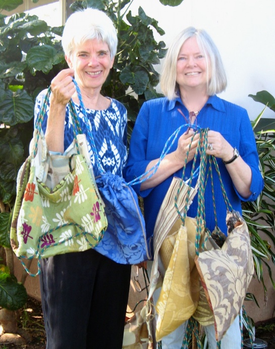 Marylou Melinger (left) , one of the founders of A Cup of Cold Water, received 10 new bags from Joy Webster, owner of Bag of Joy. Courtesy photo.