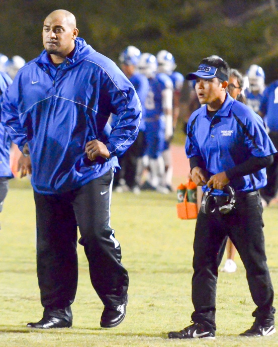 Maui High head football coach David Bui (right) stepped down Tuesday, citing family reasons for his decision. Bui is shown with assistant coach Kamaloni Vainikolo in the Sabers' 2014 season-ending game against Lahainaluna. Photo by Rodney S. Yap.