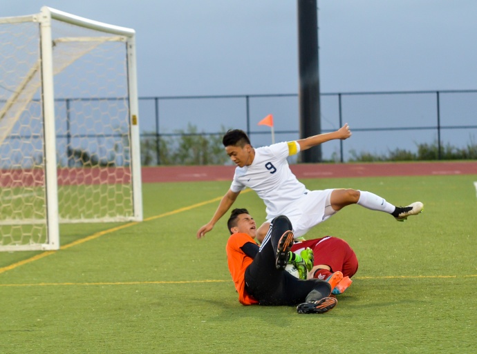 Kamehameha Maui's Bryant Kubo (9) and goalie Keola Paredes shut down a breakaway by Kalani's Takahiro Kosins during first-half action Saturday. Photo by Rodney S. Yap.