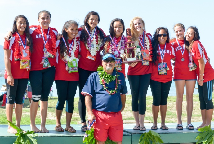 Seabury Hall girls and head coach Paul Kauhane Lu'uwai wear their silver medals proud Saturday after finishing second to Punahou at the state outrigger canoe championships at Kahului Harbor. Photo by Rodney S. Yap. 