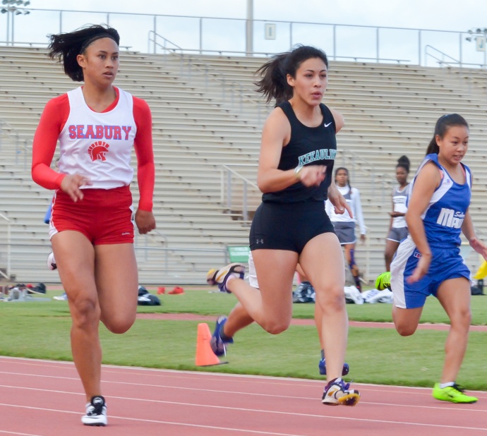 Seabury Hall's Elle Biga pushes King Kekaulike's Kameha Medallada during their heat of the girls varsity 100-meter dash Friday at the Yamamoto Track & Field Facility. Medallada won the event with a winning time of 13.06 seconds. Biga was third in 13.35. Photo by Rodney S. Yap.