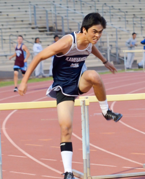 Kamehameha Maui's Jesse Amaral charges over the hurdle in the 300 intermediates. Photo by Rodney S. Yap.