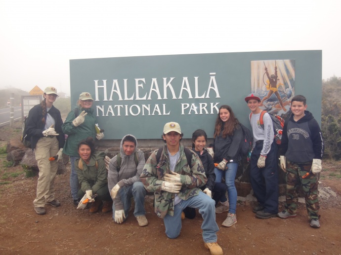 Interns at park entrance sign. Photo courtesy Haleakalā National Park.