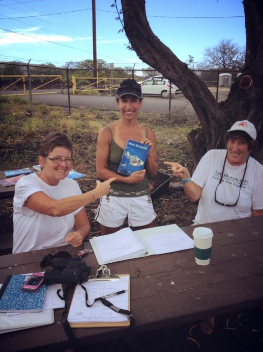 Margo pictured (far right at the volunteer information station helping a visitor) while she was volunteering at the  ʻĀhihi Kīnaʻu Natural Area Reserve as a volunteer interpretive guide.  Courtesy photos.