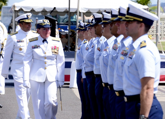 Crew members from the Fourteenth Coast Guard District stand at attention as Rear Adm. Cari B. Thomas and Rear Adm. Vincent B. Atkins inspect the crew during a change of command ceremony at Base Honolulu, May 28, 2015. During the ceremony, Atkins relieved Thomas as commander of the Fourteenth Coast Guard District. (U.S. Coast Guard photo by Petty Officer 3rd Class Melissa E. McKenzie)