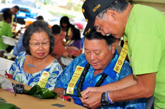 “Blossoms for the Brave” - Mayor Arakawa and wife Ann learning how to make a Ti leaf lei (5.24.2013) File photo courtesy County of Maui.