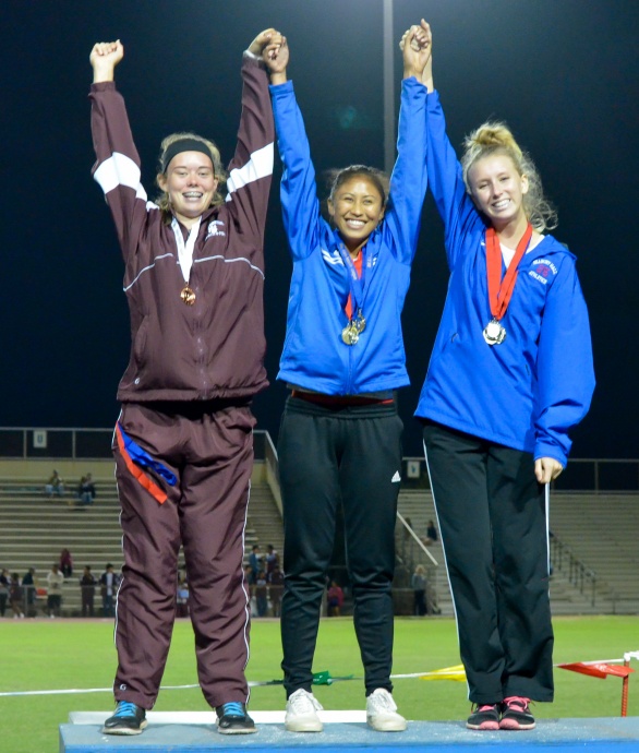 Seabury Hall's Elle Bega (middle) won the gold medal in the  girls triple jump. Teammate Christy Fell was second Baldwin's Kaitlin Smith (left) finished third. Photo by Rodney S. Yap.