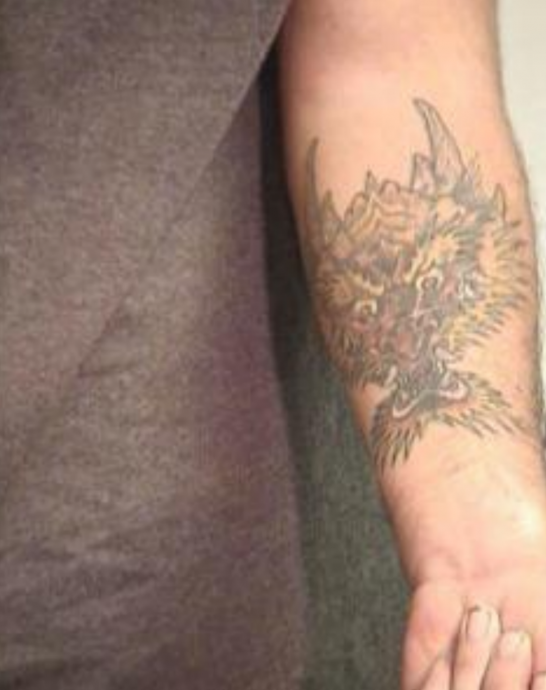 Leif VALDEZ also known as Lucas Rauh, has a tattoo of a dragon head on his left forearm.