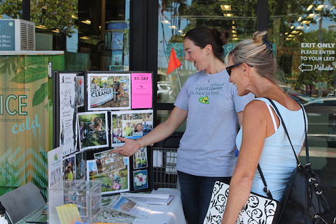 MMN Community Relations Manager Jen Cox speaks with a Whole Foods Market customer about MMN's programs during the April 1 5% Community Support Day. Photo courtesy of Whole Foods Market Kahului.