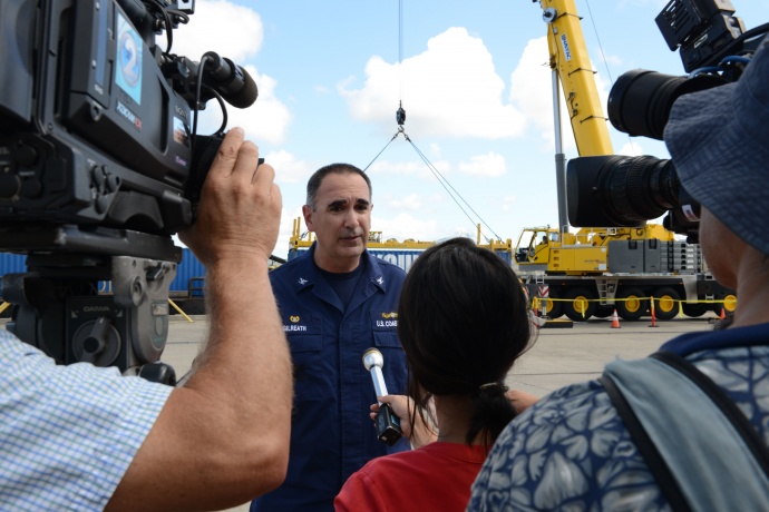 Capt. Shannon Gilreath, Coast Guard Sector Honolulu commanding officer, conducts interviews with local media during the Hawaii Alternate Port Concept Full Scale Exercise at Joint Base Pearl Harbor-Hickam, June 5, 2015. The purpose of this exercise is to prepare the State, Navy, Coast Guard and industry response partners for their roles during a major catastrophic event that closes the Port of Honolulu and requires the activation of the Alternate Port in Pearl Harbor. (U.S. Coast Guard photo by Petty Officer 2nd Class Tara Molle)