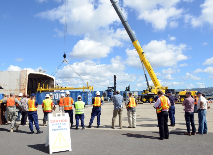 Personnel from the Coast Guard, Navy, state of Hawaii and key industries partners observe crane operations during the Hawaii Alternate Port Concept Full Scale Exercise at Joint Base Pearl Harbor-Hickam, June 5, 2015. The purpose of this exercise is to prepare the state, Navy, Coast Guard and industry response partners for their roles during a major catastrophic event that closes the Port of Honolulu and requires the activation of the Alternate Port in Pearl Harbor. (U.S. Coast Guard photo by Petty Officer 2nd Class Tara Molle)
