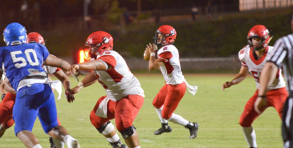 Lahainaluna quarterback Etuati Storer (2) looks for a teammate open in the end zone. Photo by Rodney S. Yap.