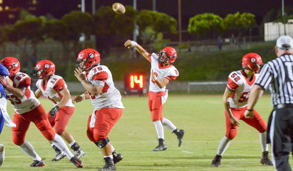 Lahainaluna quarterback Etuati Storer (2) throws a pass attempt into the end zone. The pass was broken up by Maui High's Nathan Vierra. Photo by Rodney S. Yap.