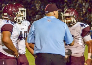 Baldwin defensive line coach Kawika Kahui talks to several of his players during a time out Friday. Photo by Rodney S. Yap.