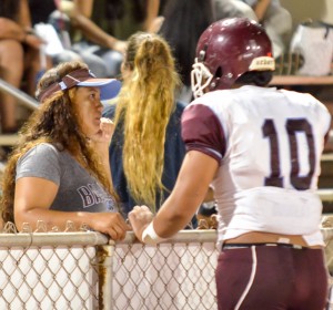Baldwin's Chazz Sa'u checks in with a concern family member on the sidelines Friday. Photo by Rodney S. Yap.