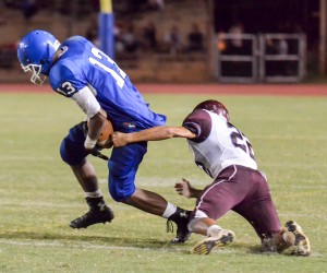 Maui High's Keith Penias (13) escapes the grasp of Baldwin's Jac Keoni Yoruw. Photo by Rodney S. Yap.