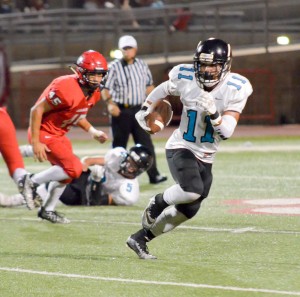 King Kekaulike's Kawika Akahi finds running room in the first half against Lahainaluna. Photo by Rodney S. Yap.