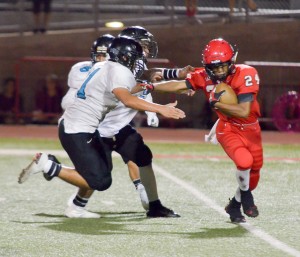 Lahainaluna's Elijah Ragudo tries to escape the grasp of a pair of King Kekaulike defenders. Photo by Rodney S. Yap.