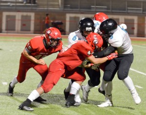 Lahainaluna lineman Ivan Upfold-Pante (44) lowers his head on King Kekaulike's Kimo Pacheco in Saturday's MIL Division II football game at Sue Cooley Stadium in Lahaina. Photo by Rodney S. Yap.