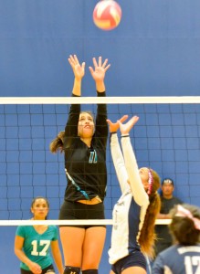 Kamehameha Warriors' setter Danielle Brown tries to go over the block attempt from King Kekaulike's Breannalye Rodrigues (11). Photo by Rodney S. Yap.