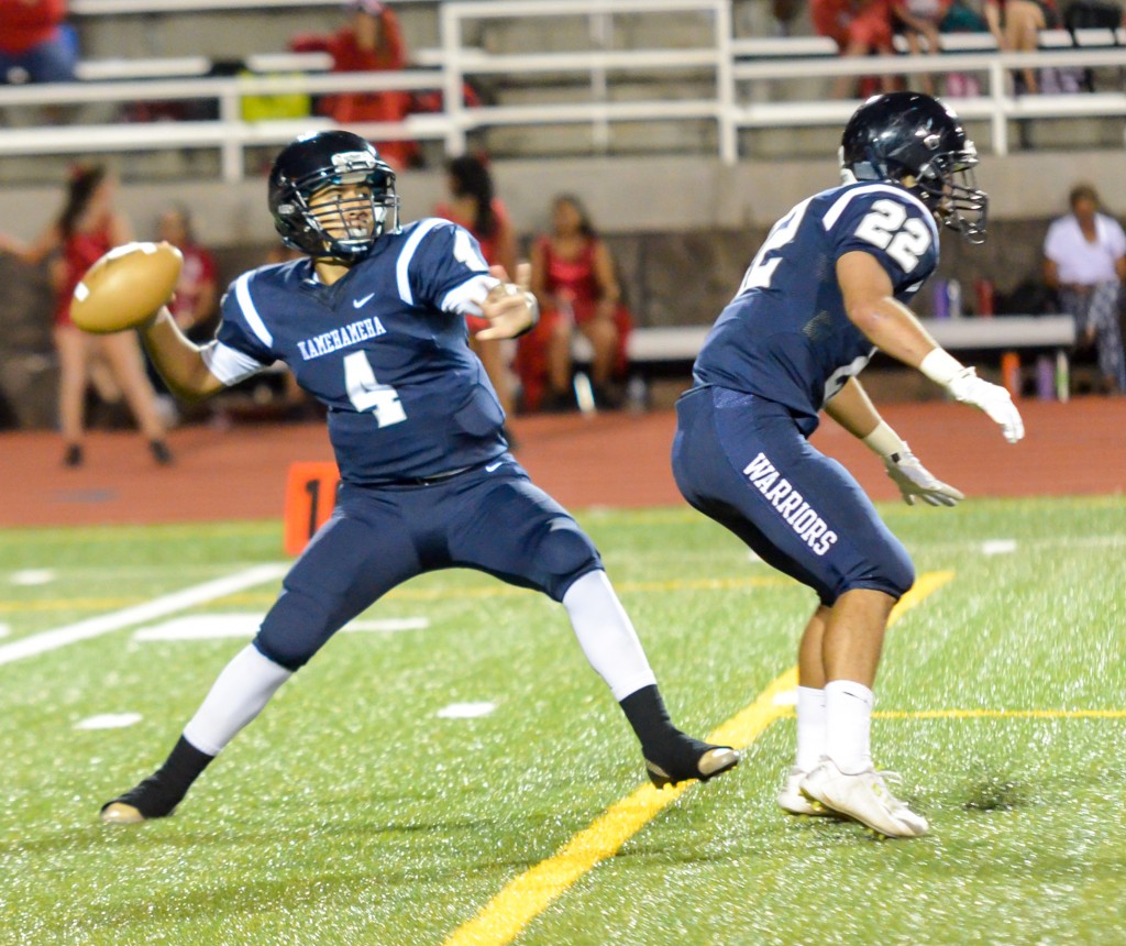 Kamehameha Maui quarterback Kainoa Sanchez (4) throws this deep ball behind the block of teammate Covy Cremer (22). Photo by Rodney S. Yap.