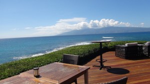 View of Pacific Ocean from outdoor patio at Merriman's Kapalua.  Photo by Kiaora Bohlool.