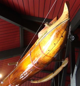 A restored koa canoe with a hand-carved honu outrigger hangs from the ceiling at Nalu's South Shore Grill. Photo by Kiaora Bohlool.
