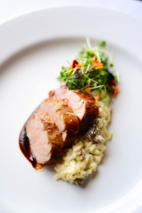 Citrus-marinated pork loin over mascarpone risotto with English peas & morel mushrooms. Photo courtesy of Fleetwood's on Front Street.