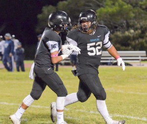 King Kekaulike players Kaena Po'ouahi and Jessie Van Zandt (16) share a moment as the exit the playing field Saturday. Photo by Rodney S. Yap.