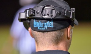 The back of King Kekaulike head coach Kyle Sanches, who happened to take a break from the head phones in the second half Saturday. Photo by Rodney S. Yap.