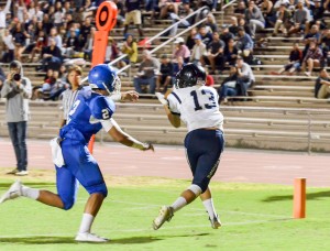 Kamehameha Maui's Maikaike English (13) hauls in this touchdown pass from quarterback Kainoa Sanchez as Maui High's Alani Malafu tries to defend. Photo by Rodney S. Yap.