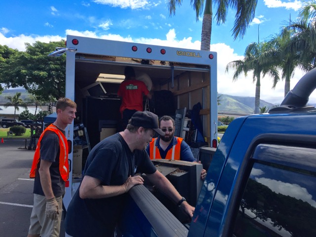 Rich Lynch (from left), Angus McKelvey and Scott Matovich help unload a TV