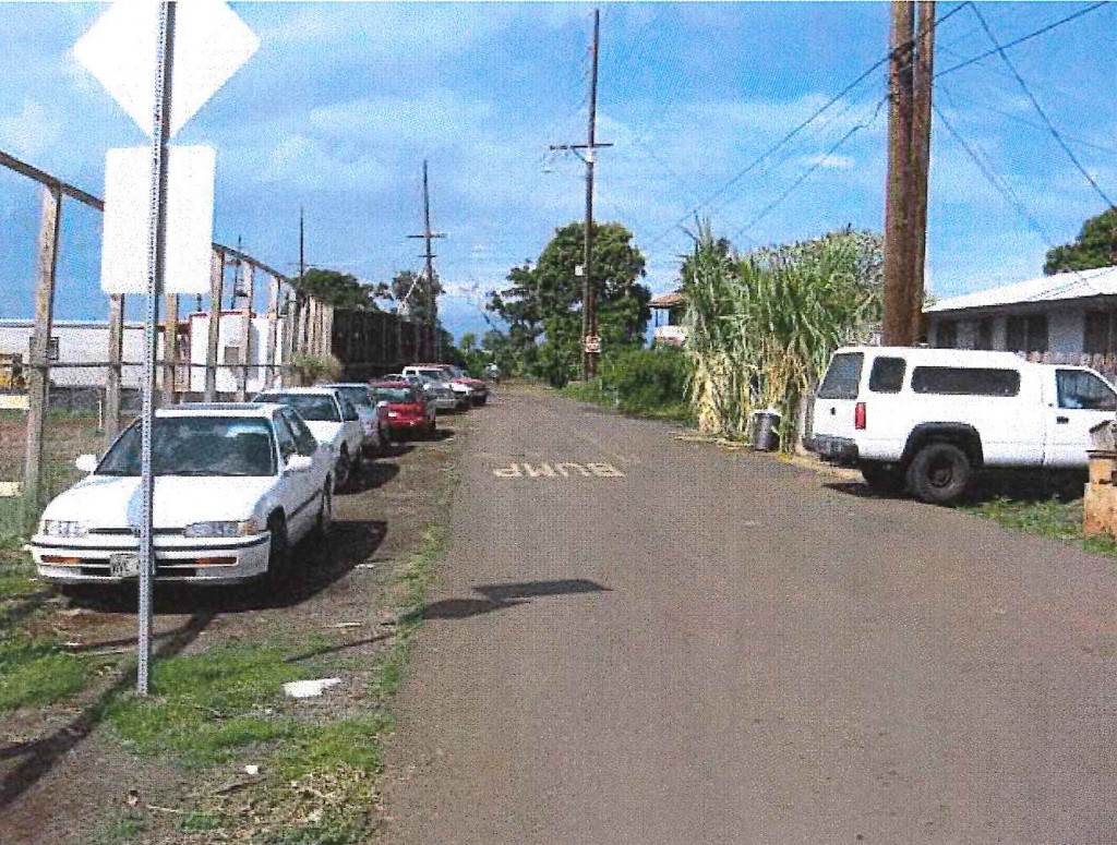View North on Kuhua Street toward Kahoma Stream Flood Control Channel. Pioneer Mill Site on Left and Old Kuhua Tract Subdivision on right. Photo credit: Munekiyo Hiraga via Final Environmental Assessment prepared for the Maui Department of Public Works.
