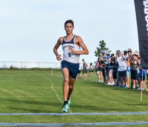 Kamehameha Kapalama's Kaeo Kruse crosses the boys three-mile race in record-breaking fashion Saturday on the campus of Seabury Hall. Photo by Rodney S. Yap.